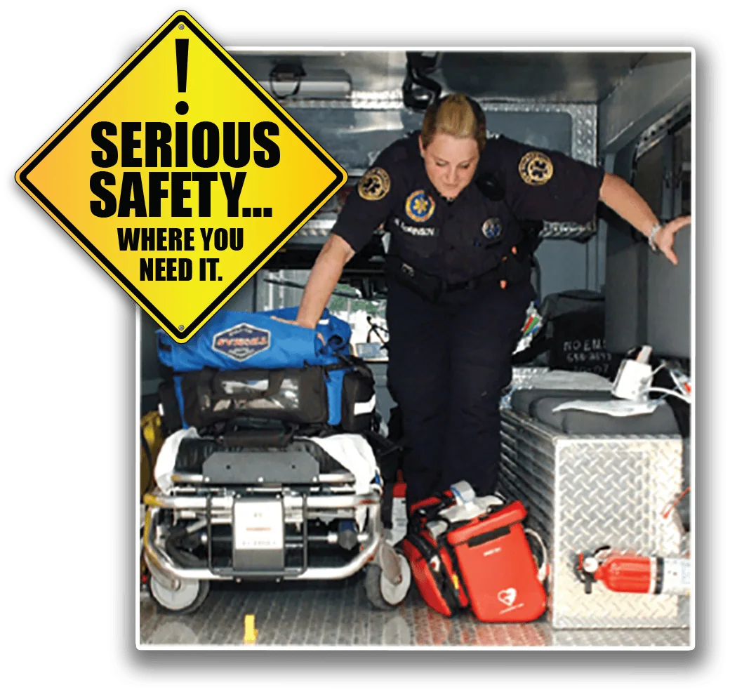A Medstat paramedic organizes equipment in an ambulance. A safety sign reads, "Serious Safety... Where You Need It.